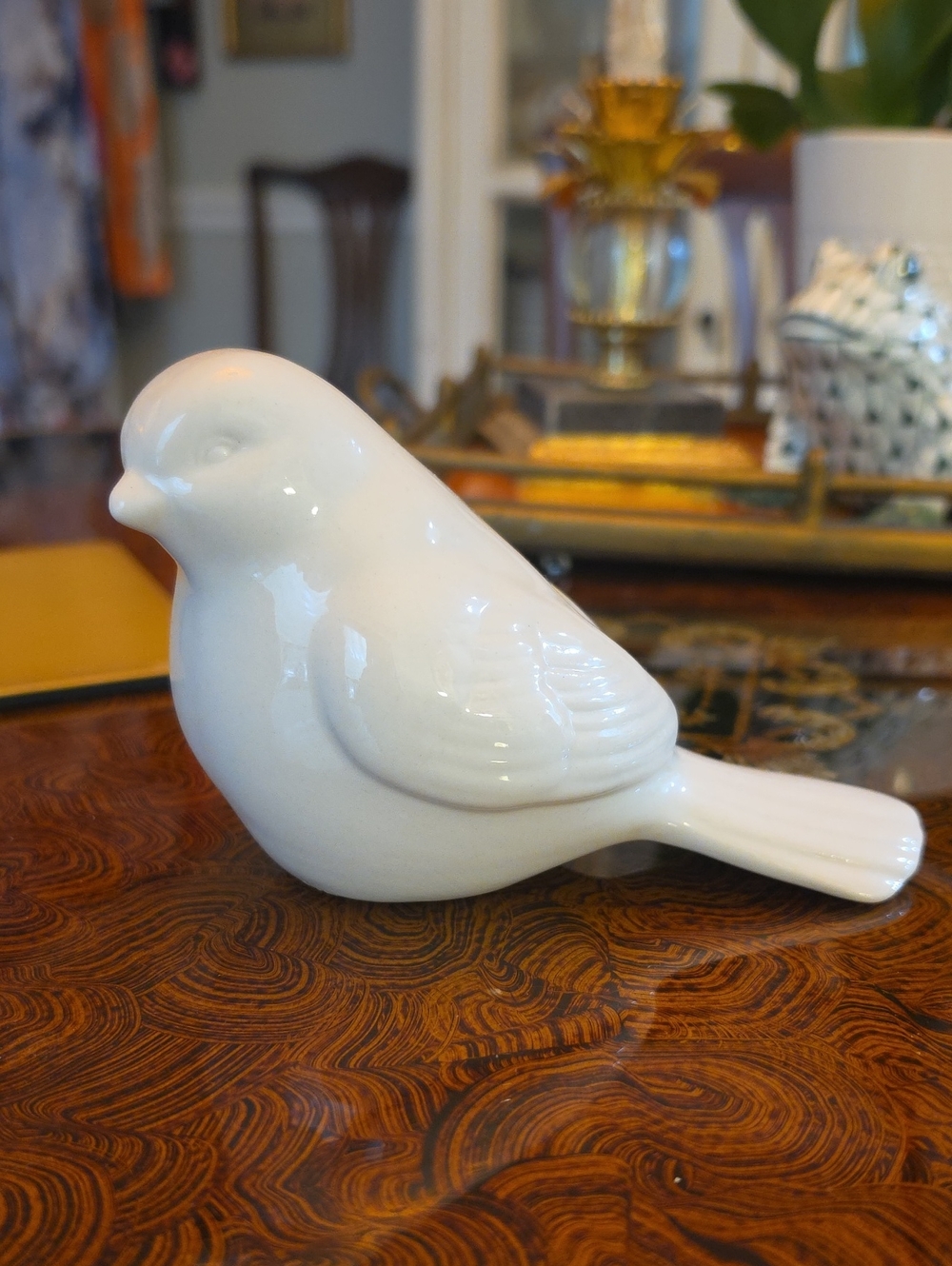 White glazed ceramic bird figurine featuring a glossy finish and a detailed wing
